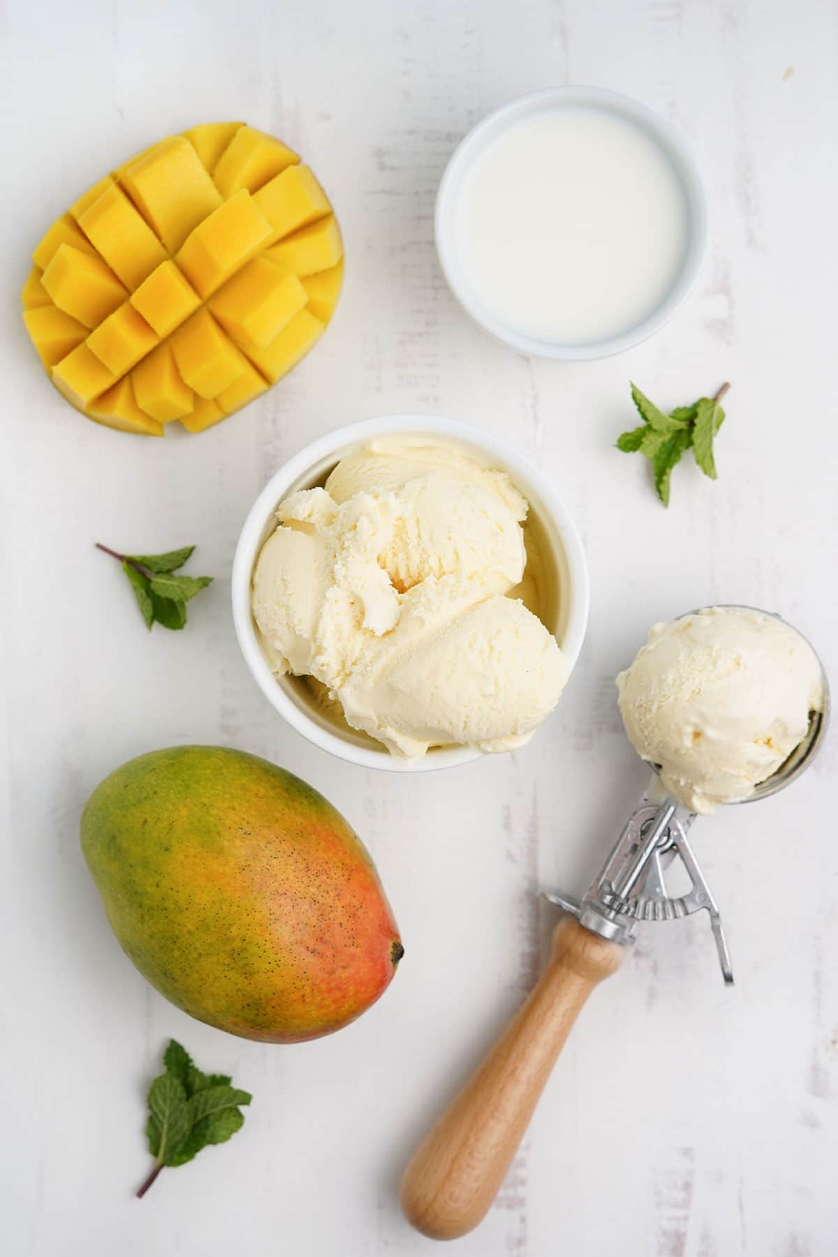 Ingredients to make a mango milkshake on the table.