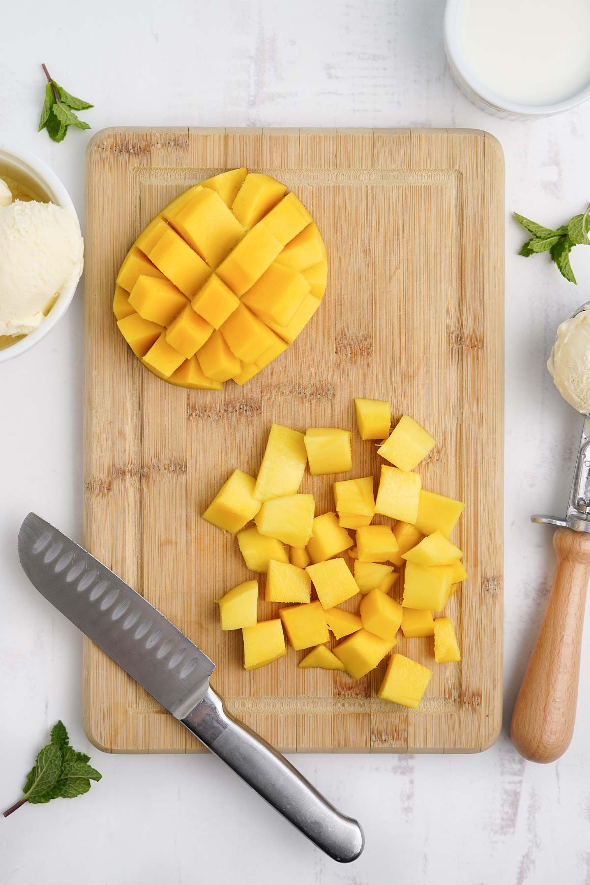 Cut mango on a cutting board.