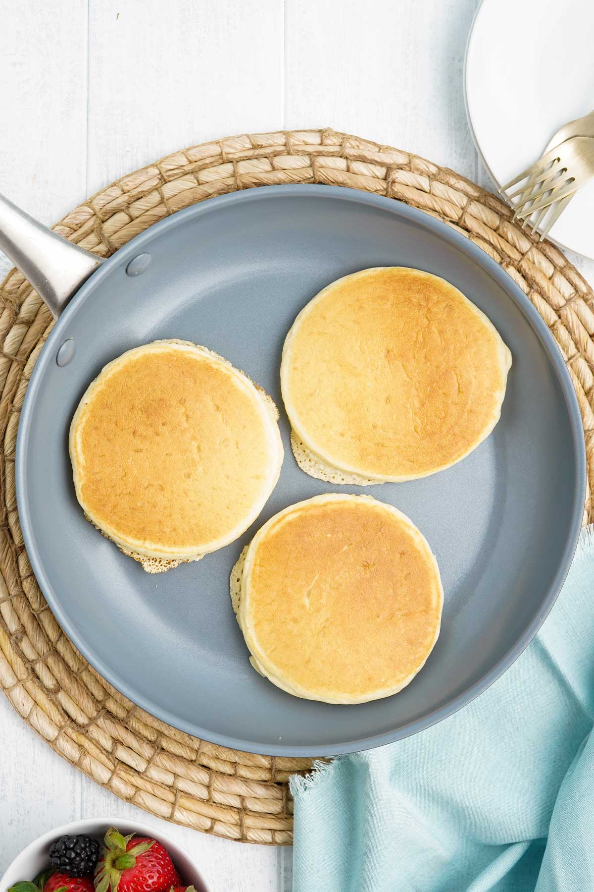 Pancakes with oat milk cooking in a pan.