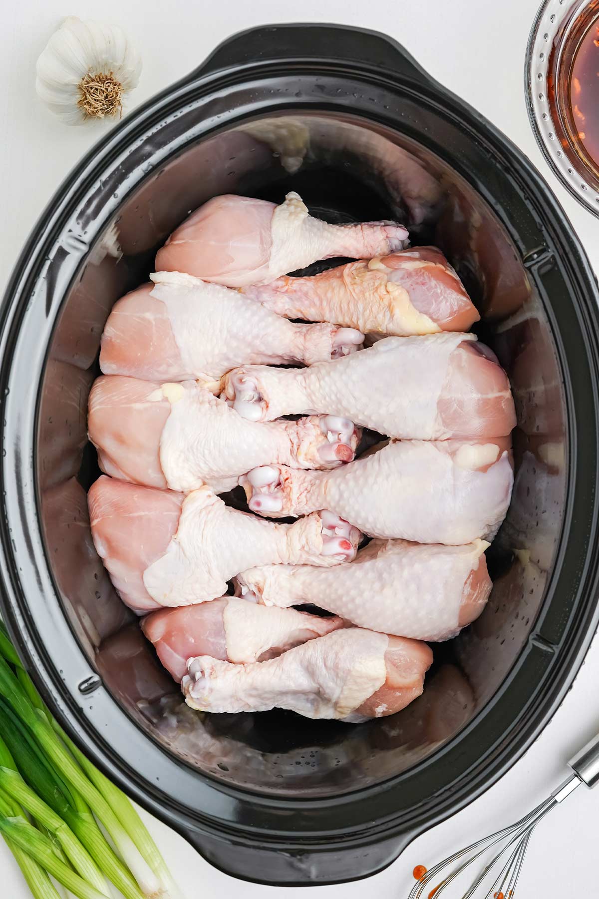 Chicken legs in the slow cooker alternating directions to fit more.