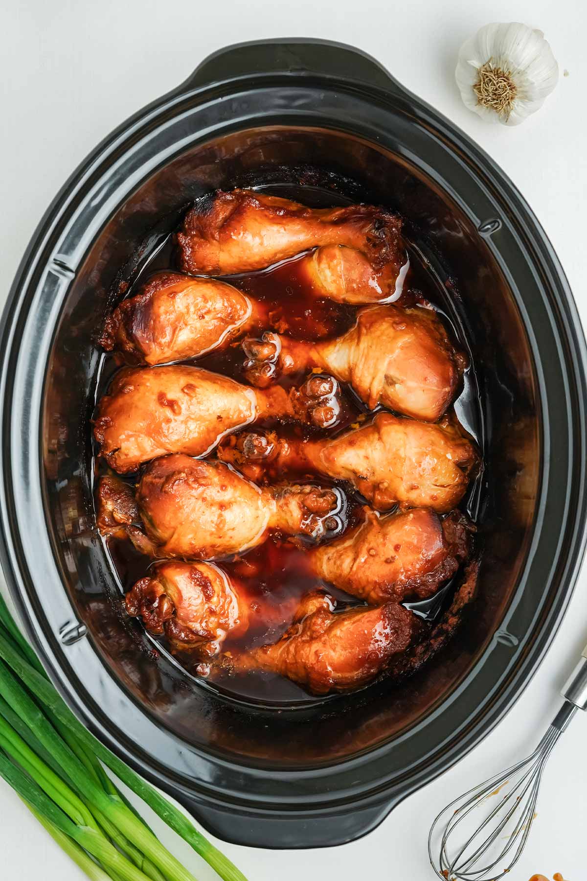 Cooked chicken drumsticks in the slow cooker done cooking.