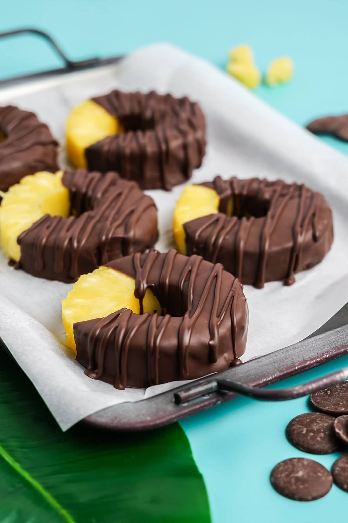 Chocolate covered pineapple rings on a tray.