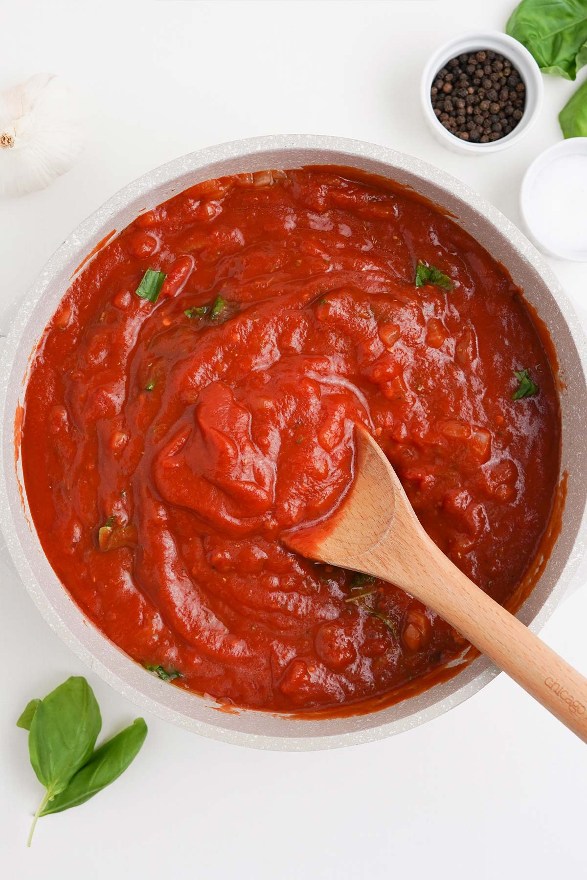 Tomato ingredients are added to the onion mixture to make spaghetti arrabiata.