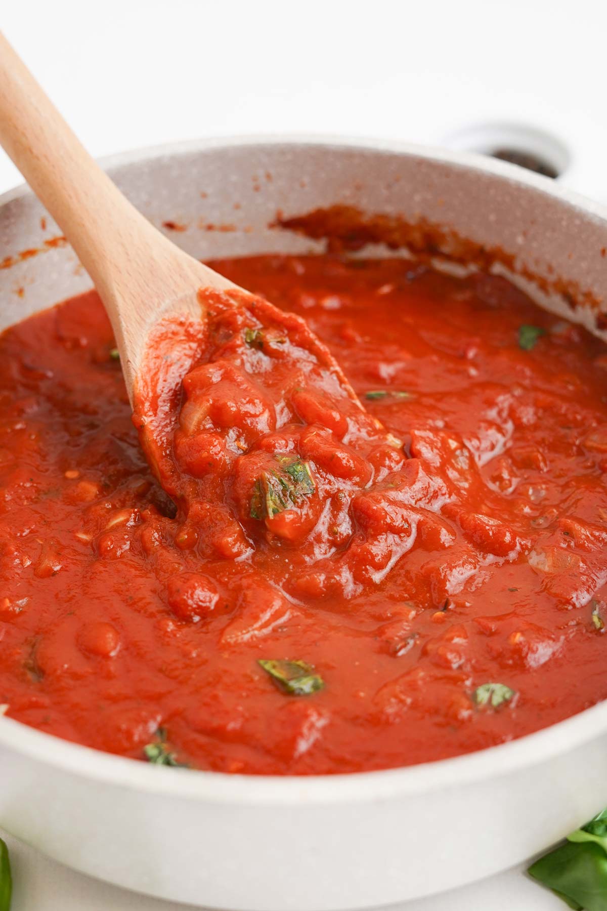 Basil is added to the arrabiata sauce.