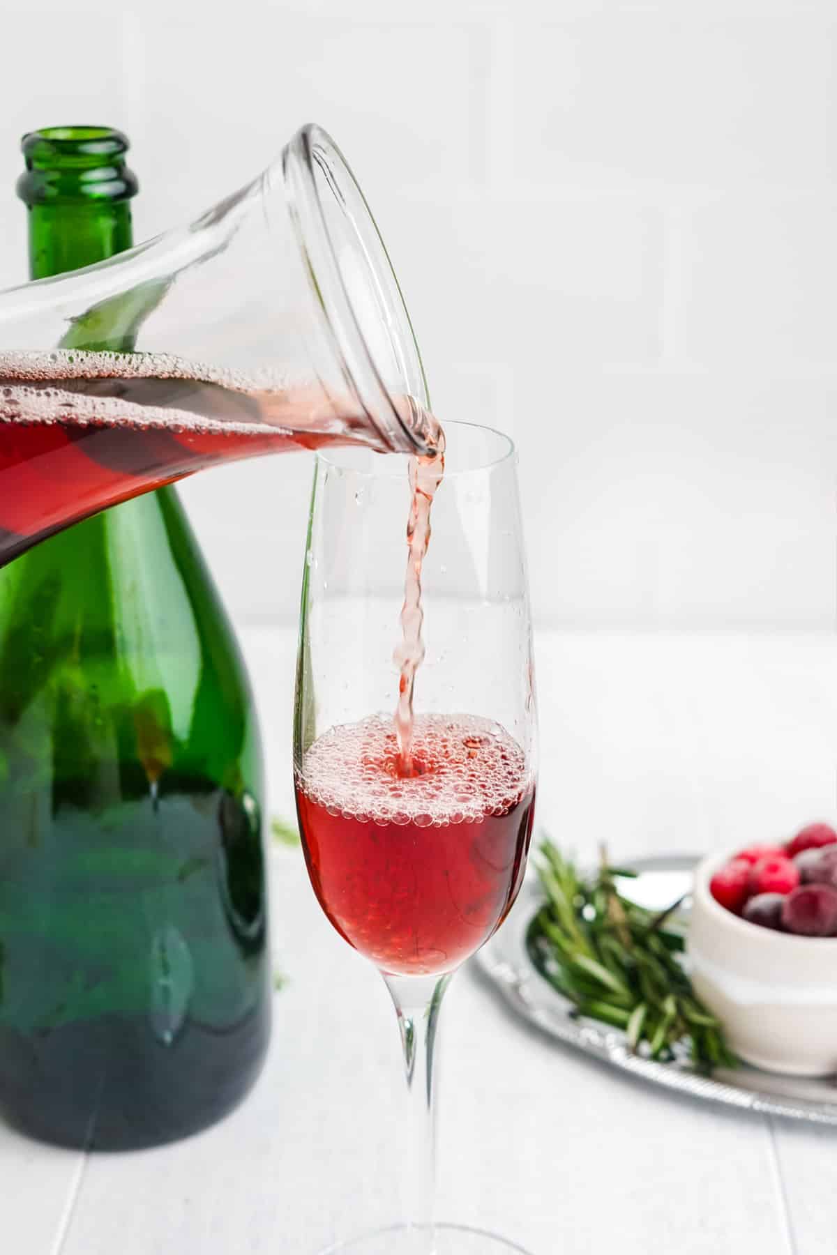 Pouring the cranberry juice in a glass.