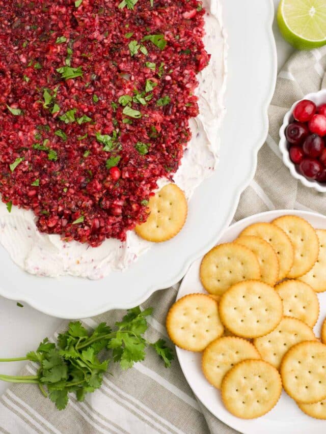 Platter of cranberry jalapeno dip on a platter with cream cheese.