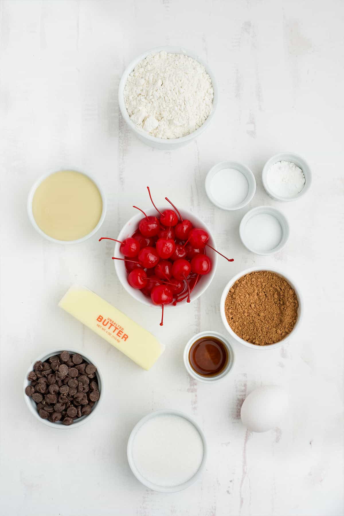Ingredients to make chocolate cherry cookies on the table.