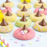 Spring blossom cookies laid out on the counter with sprinkles.