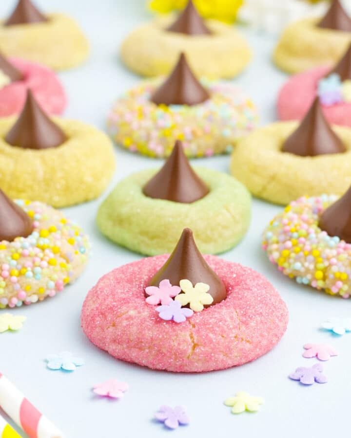 Spring blossom cookies laid out on the counter with sprinkles.