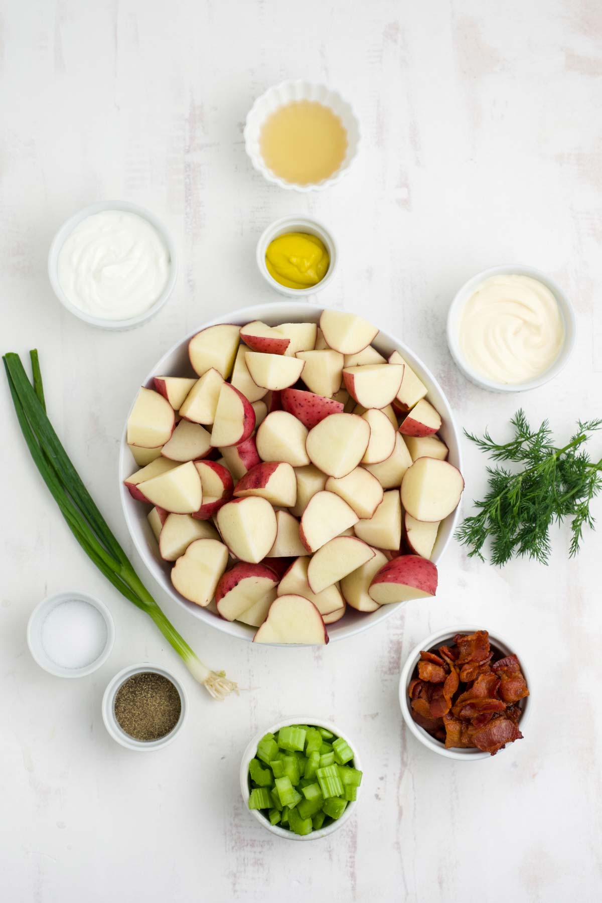 Ingredients to make red skin potato salad on the table.