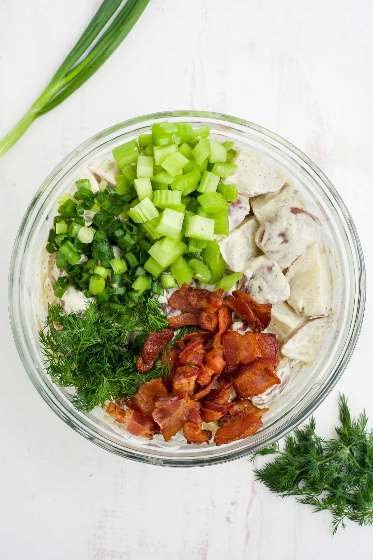 Adding the rest of the ingredients to make red skin potato salad.