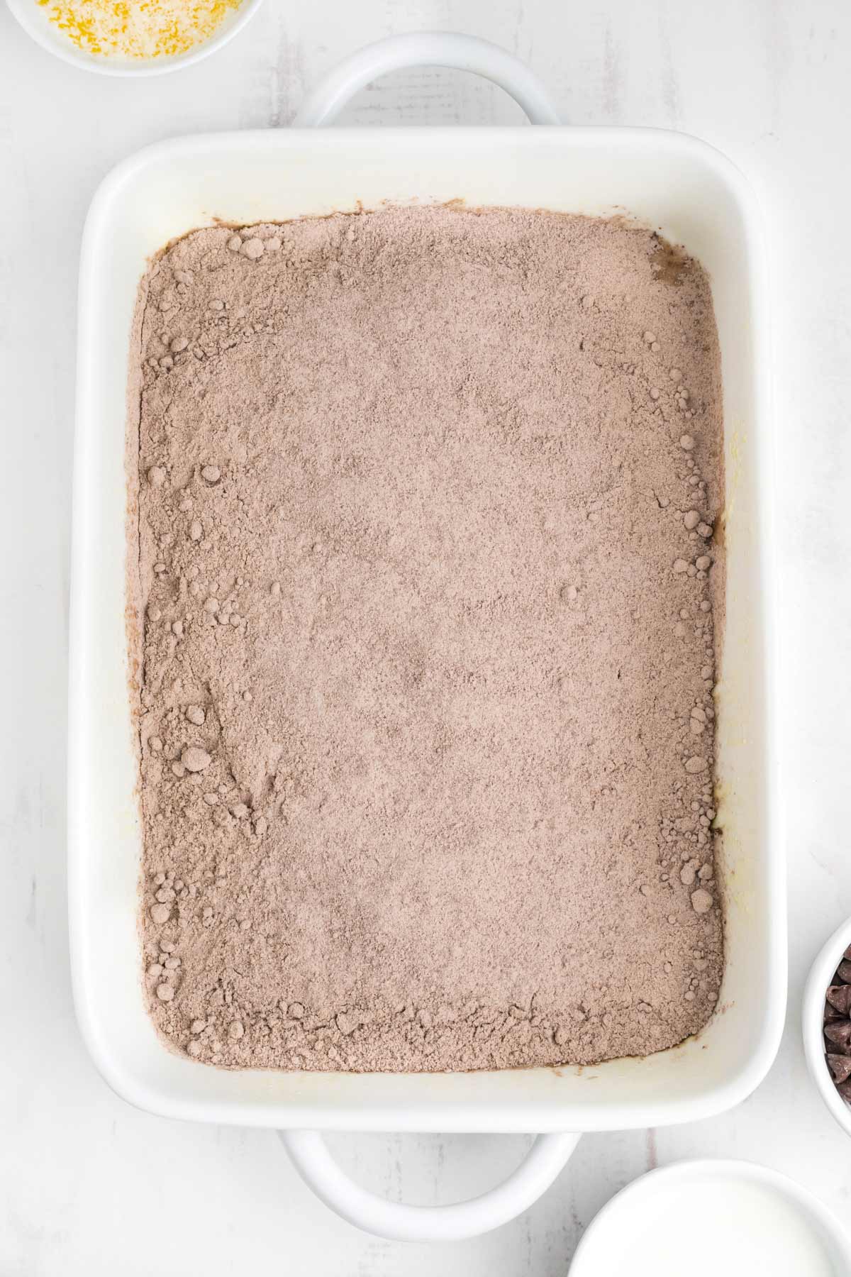 Chocolate pudding mix sprinkled over the top of the cake mix.