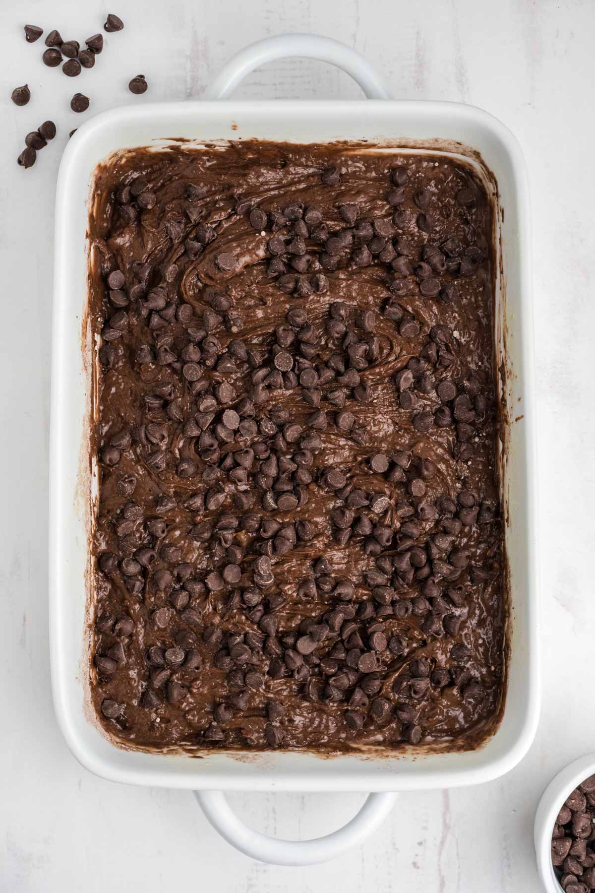 Chocolate chips over the top of the dump cake mixture.