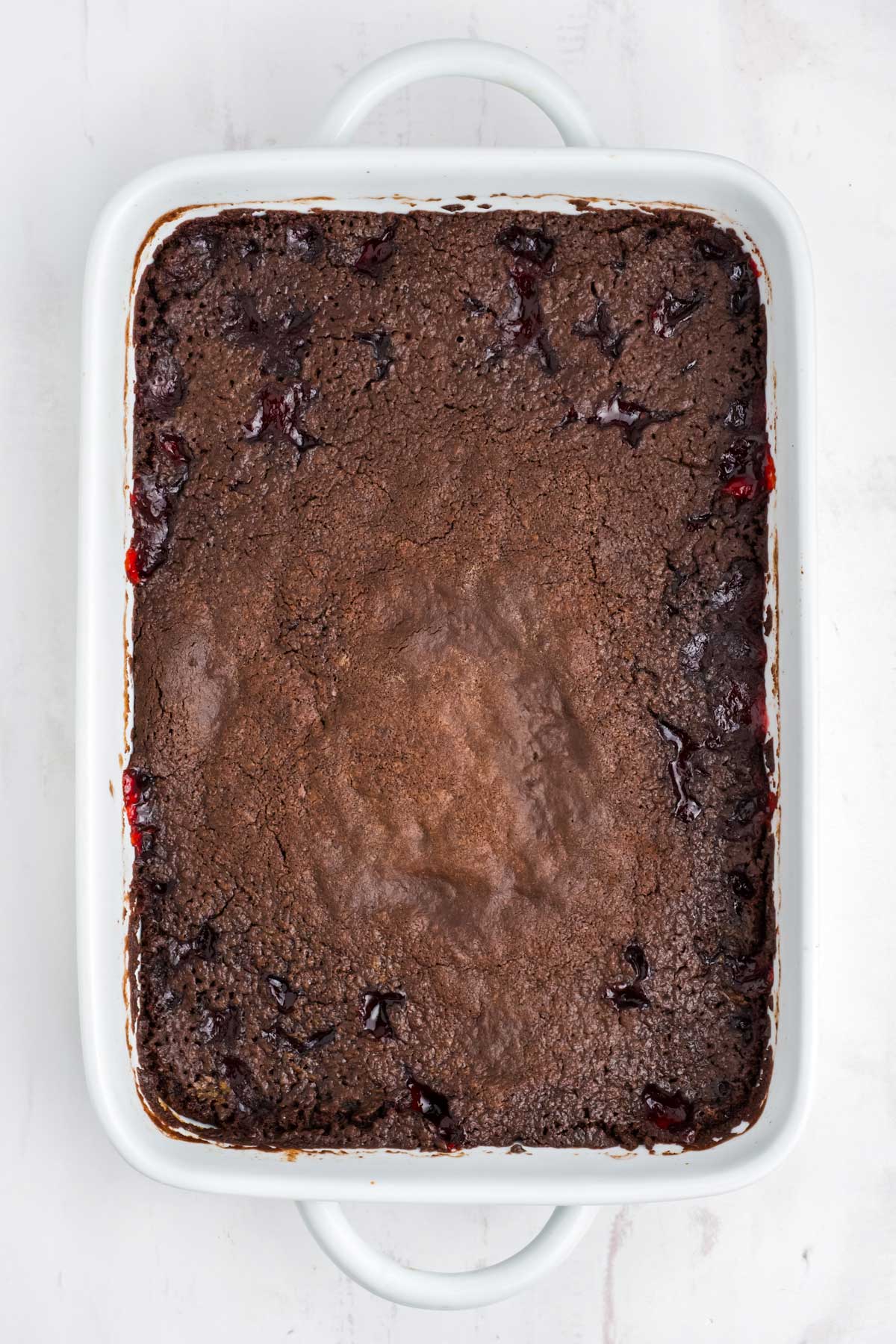 Chocolate and cherry cake after baking in the oven.