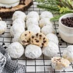 Chocolate chip snowball cookies without nuts on a wire rack on the table.