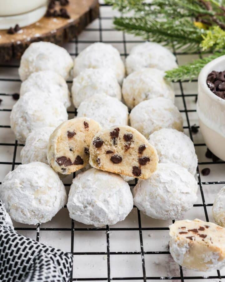 Chocolate chip snowball cookies without nuts on a wire rack on the table.