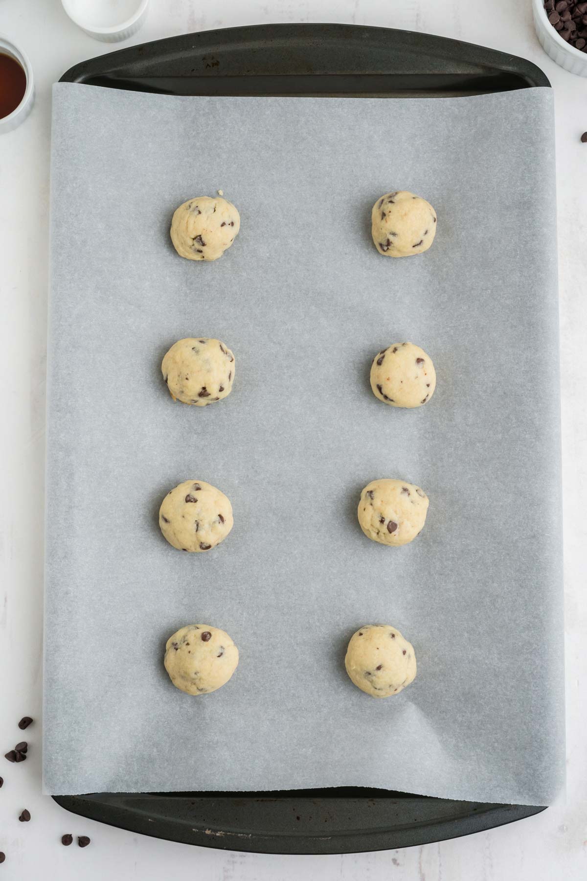 Chocolate chip snowball cookies after baking on a baking tray.
