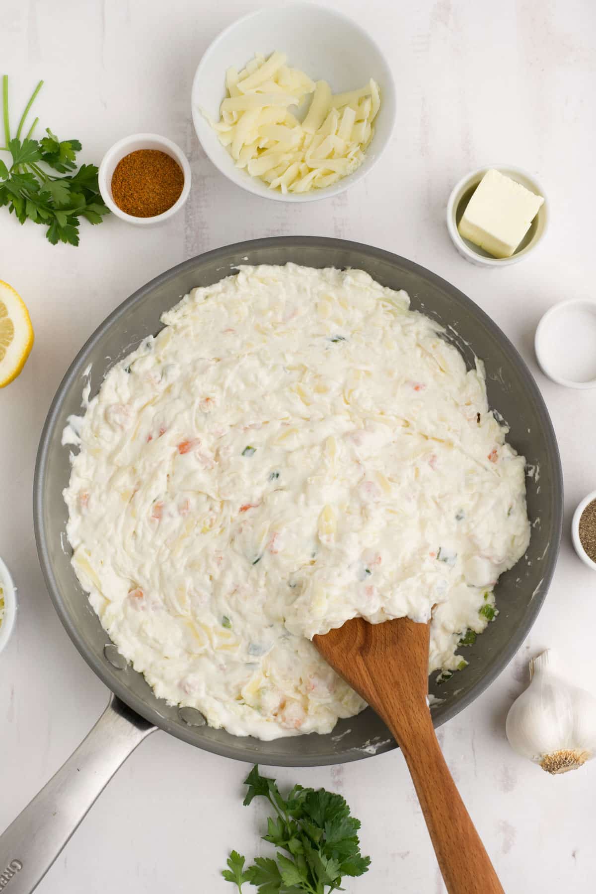 Hot shrimp dip is fully mixed together in a skillet.