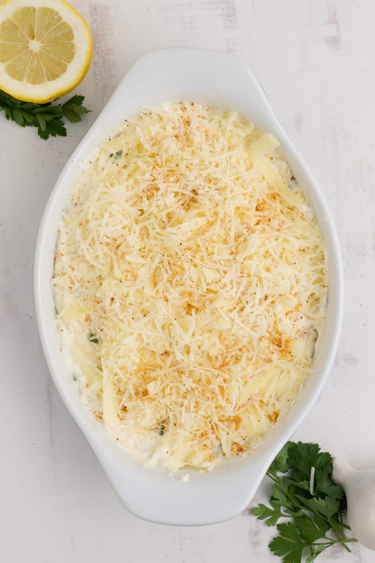 Parmesan cheese is sprinkled over the top of the shrimp mixture.