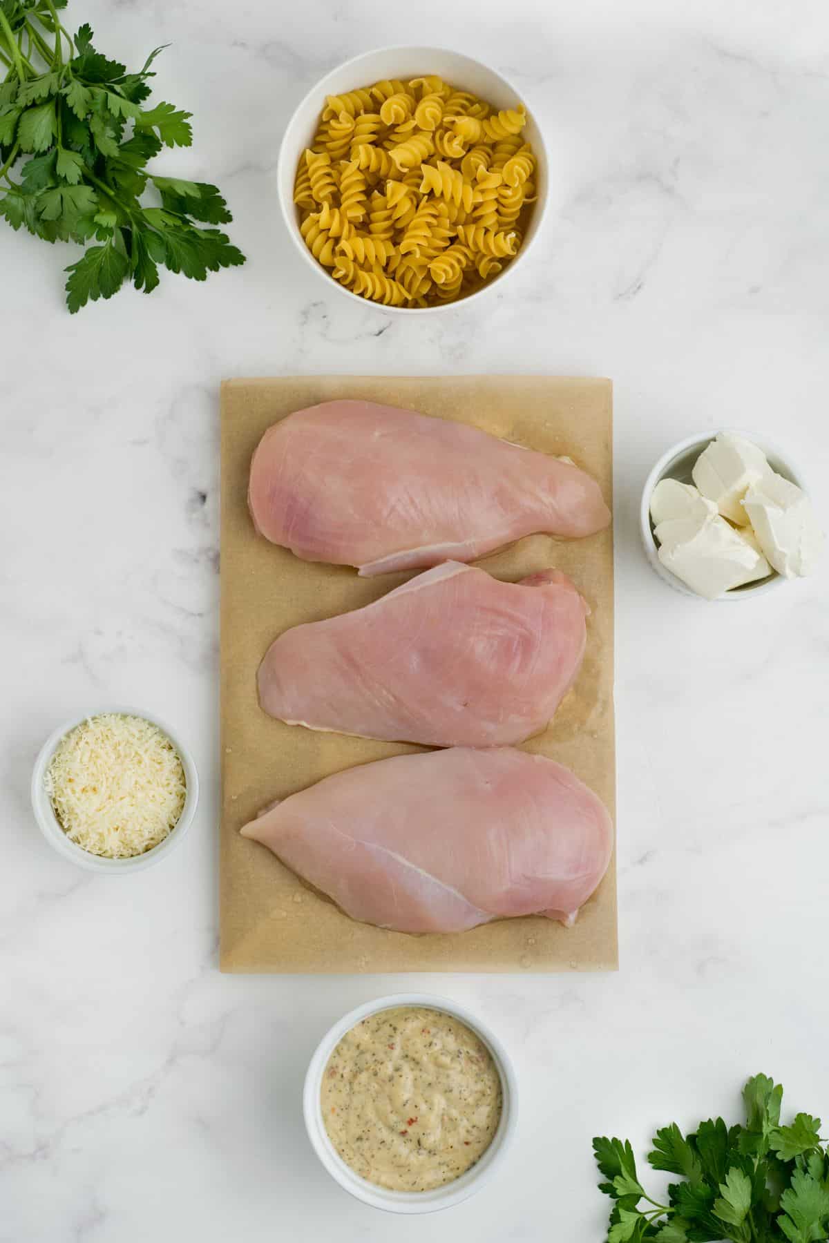 Ingredients to make slow cooker garlic parmesan chicken on the table before preparing.
