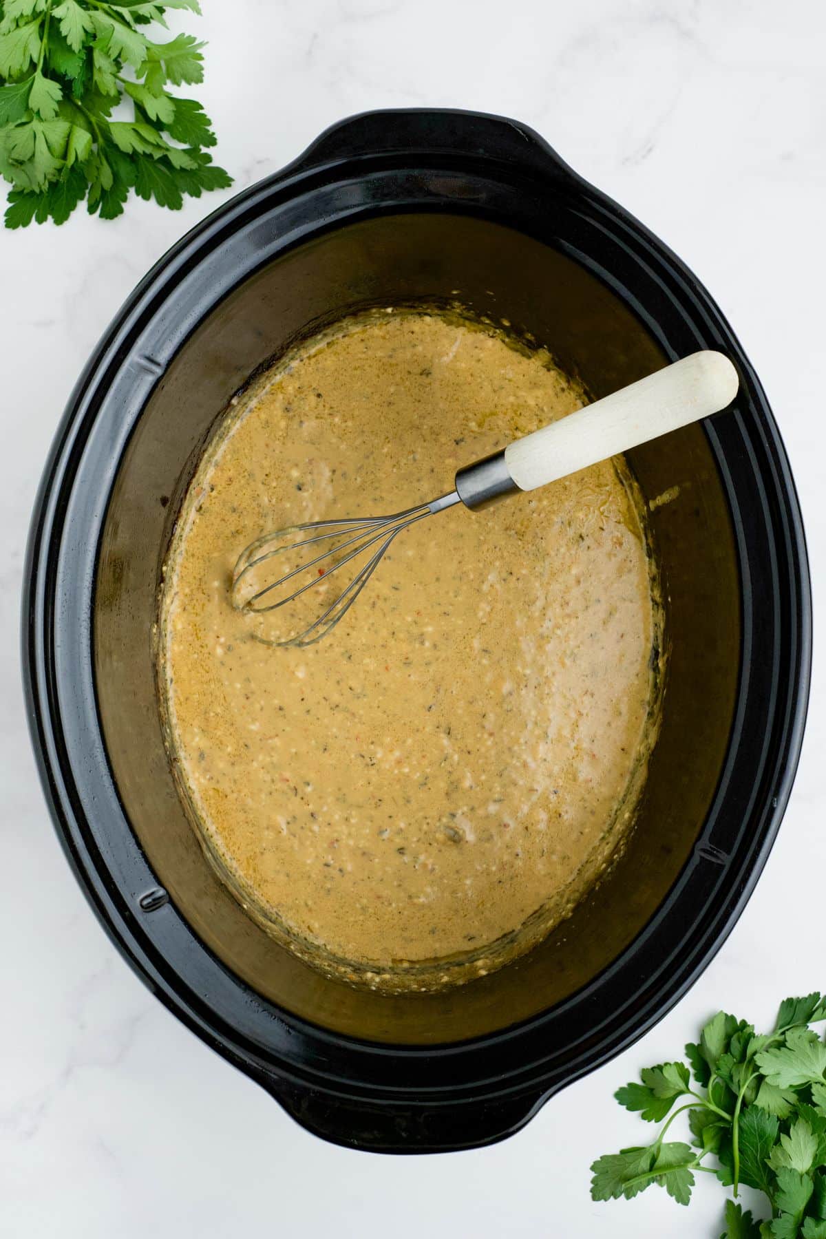 Sauce whisked together in a slow cooker.