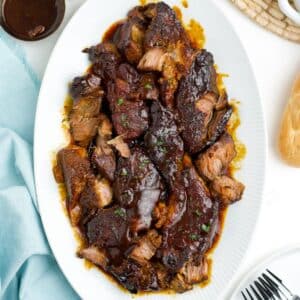 A platter of crockpot boneless pork ribs on a table.