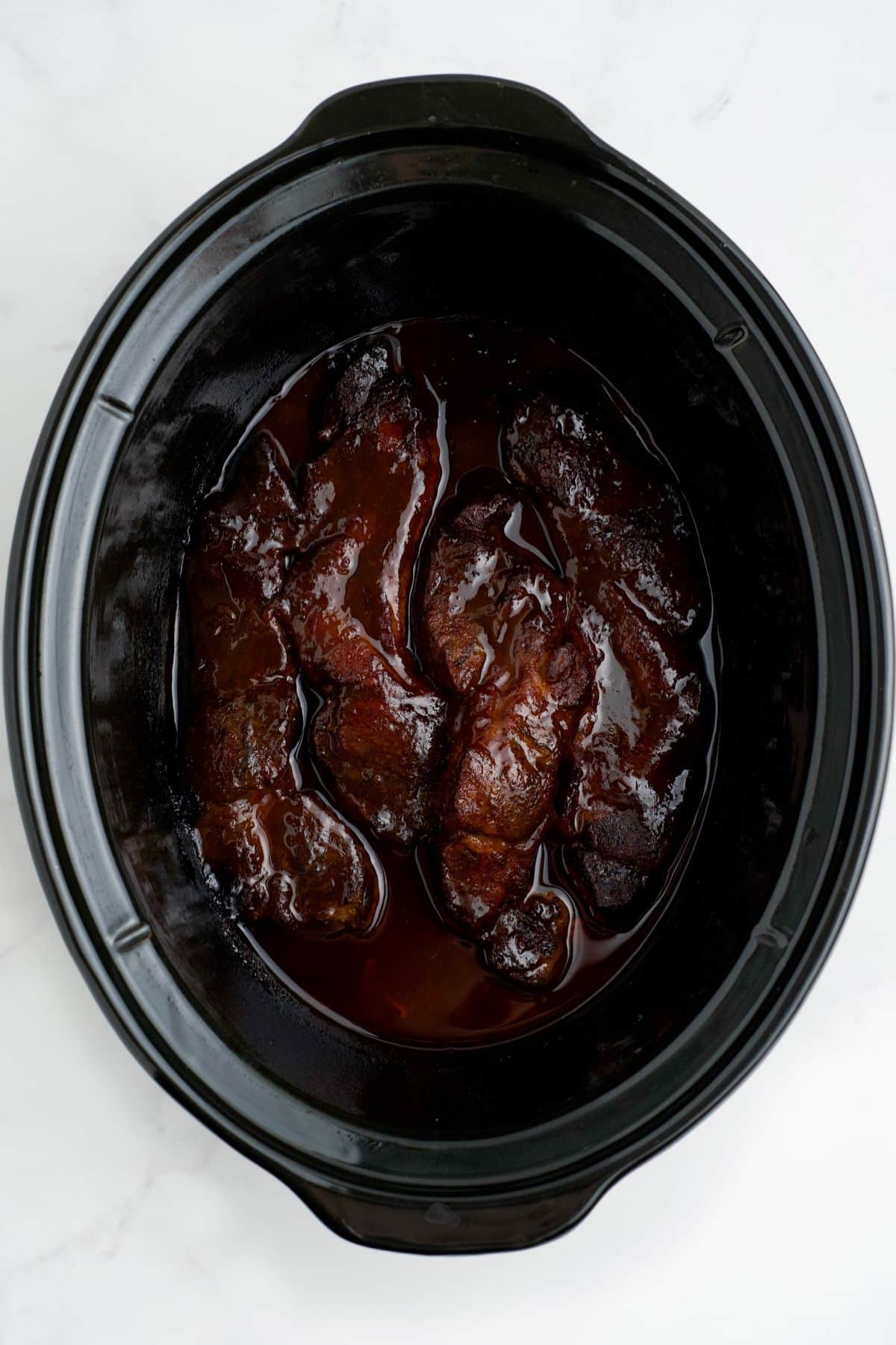 Cooked country style ribs in a crockpot.