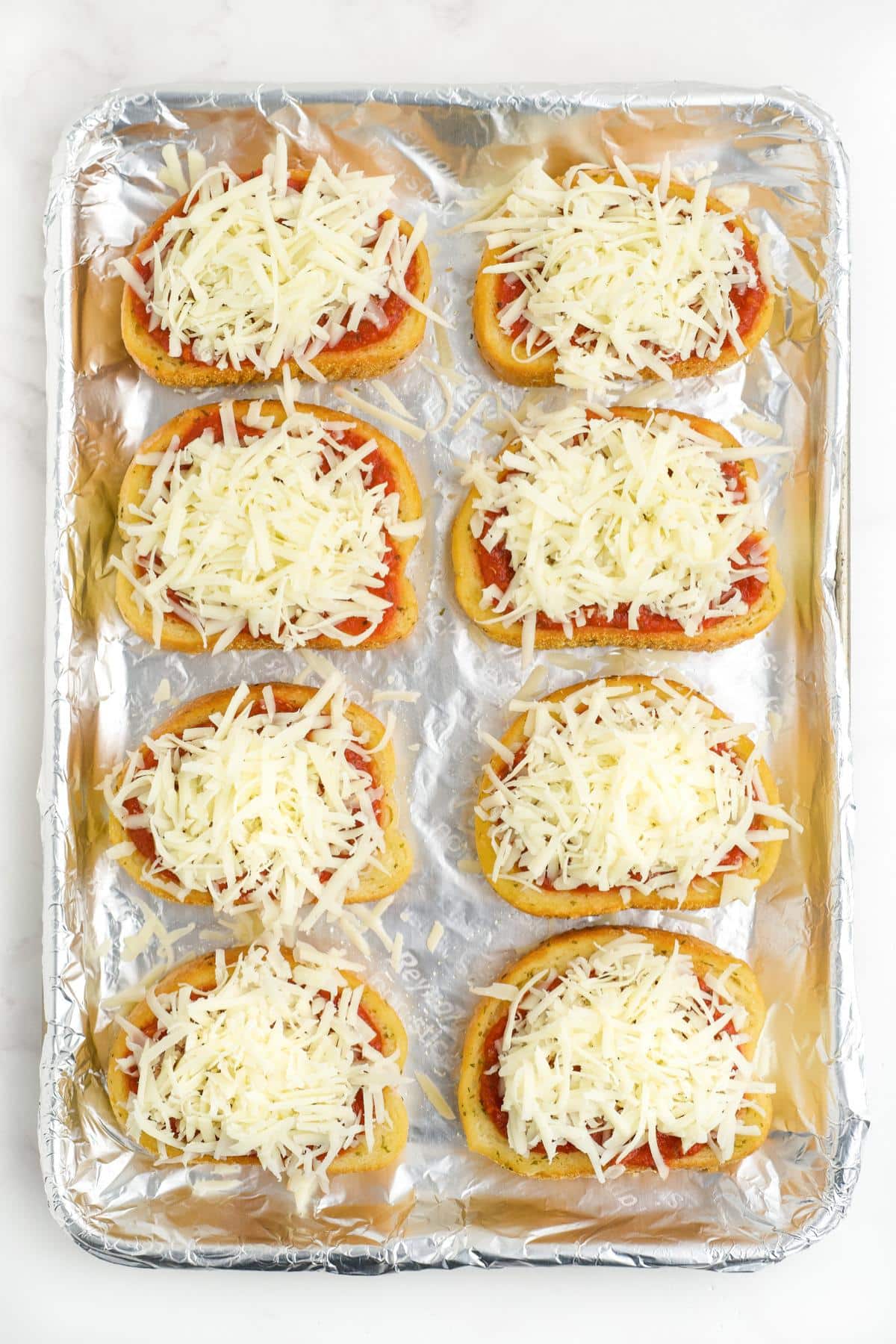 Cheese added on top of each piece of bread.