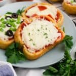 Pieces of Texas toast pizza on a gray plate.
