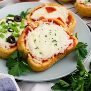 Pieces of Texas toast pizza on a gray plate.