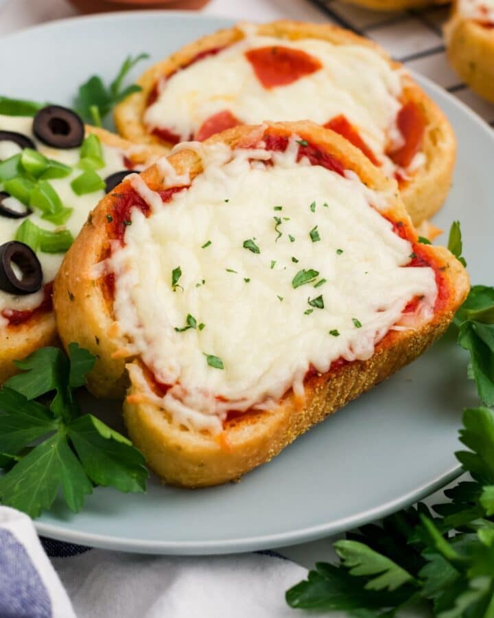 Pieces of Texas toast pizza on a gray plate.