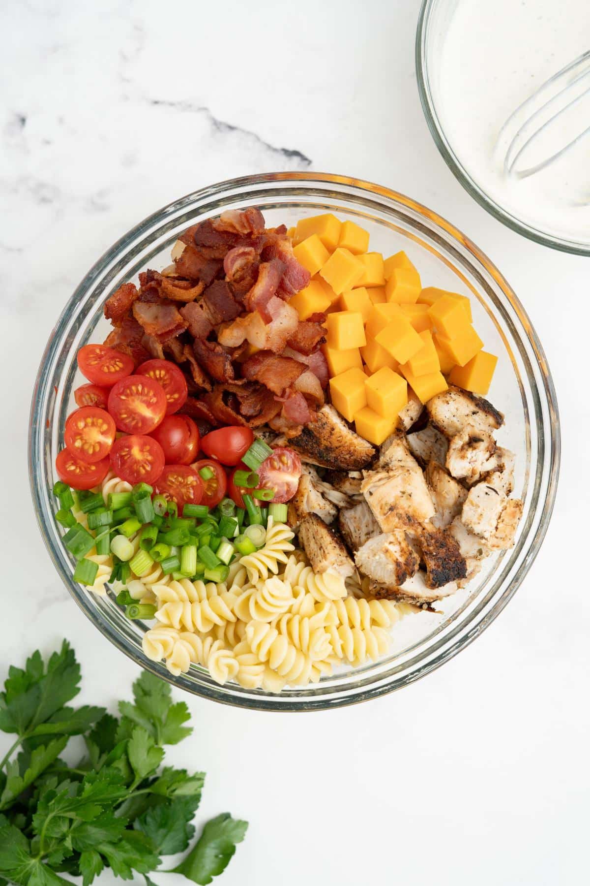 Pasta salad ingredients assembled in a bowl.