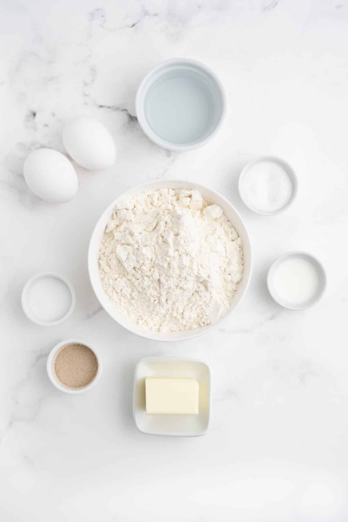 Ingredients to make hot dog buns from scratch on the table.