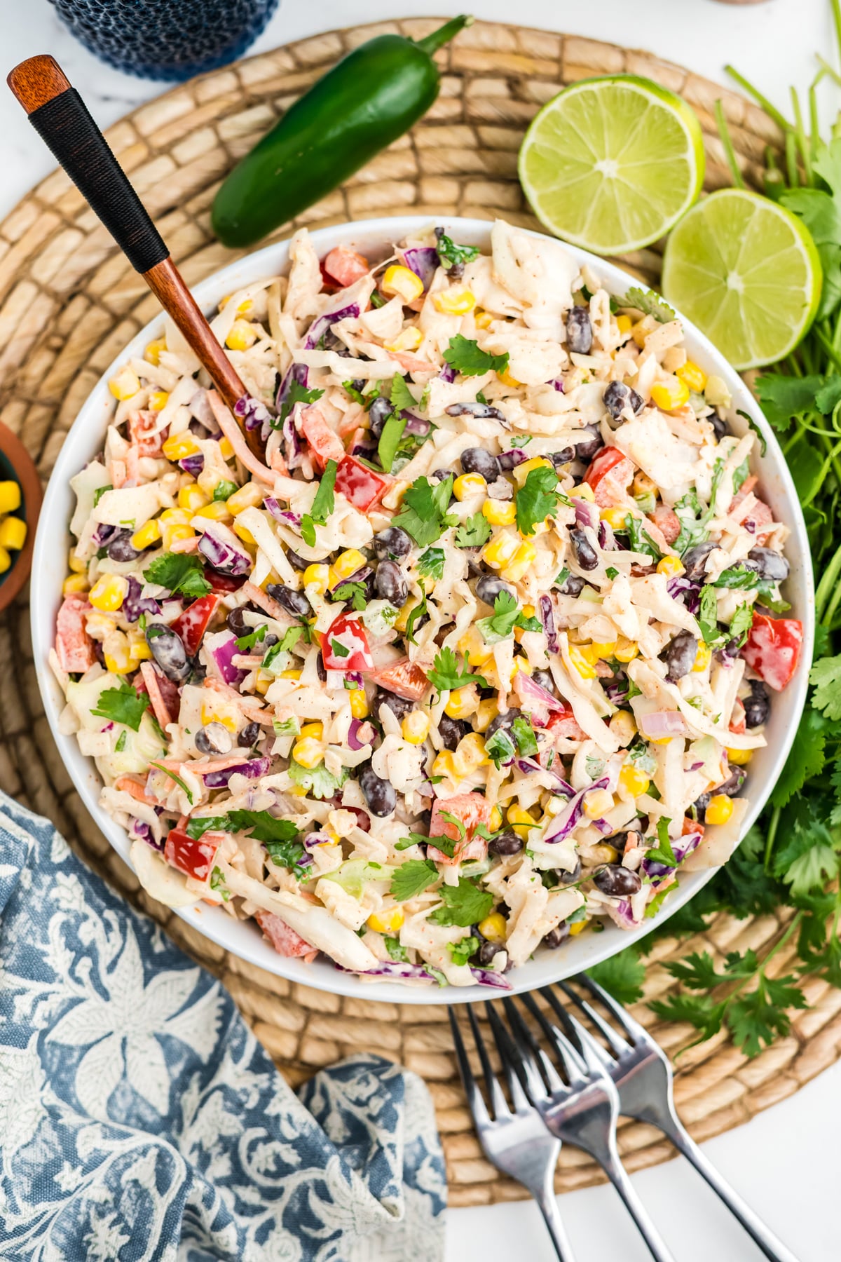 An overhead image of creamy and tangy southwest coleslaw with a spoon in it.