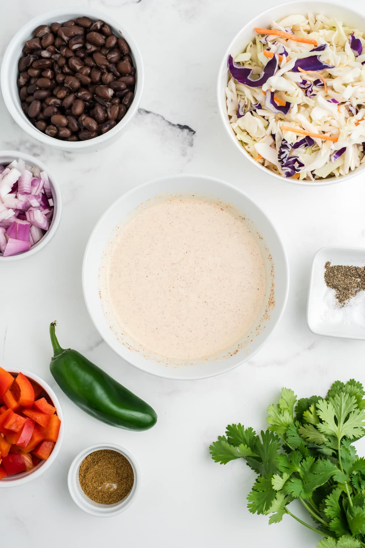 An image of southwest coleslaw sauce whisked in a bowl.