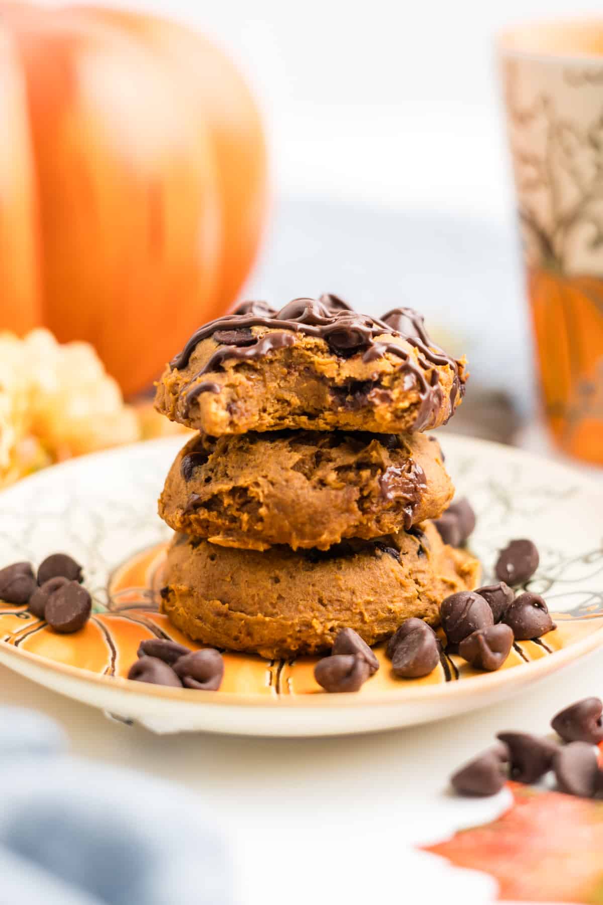 An image of 3 ingredient pumpkin cake mix cookies staked up on a plate.
