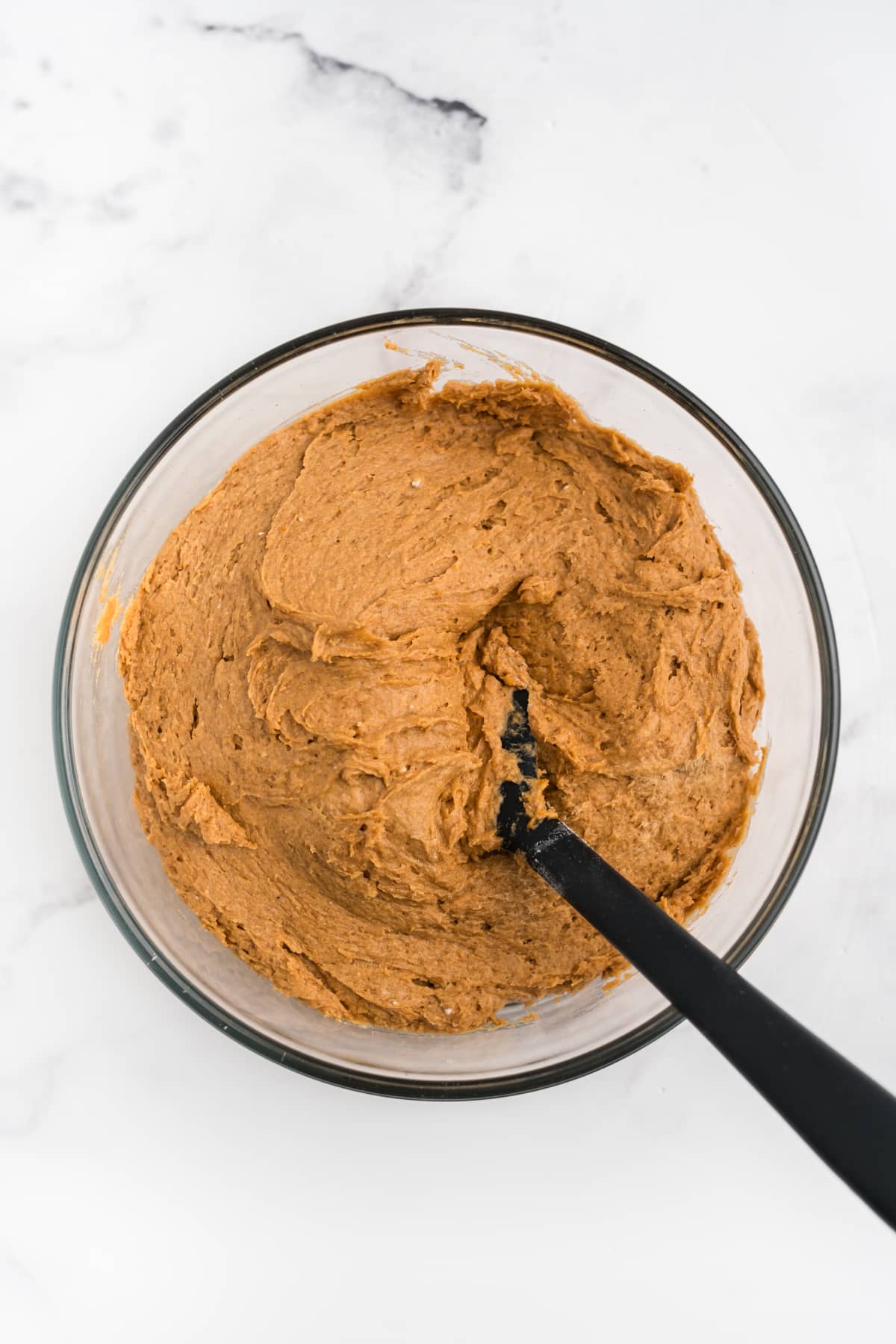 3 ingredient pumpkin cookie batter being mixed in a bowl.