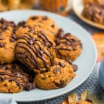 3 ingredient pumpkin cookies on a plate with melted chocolate drizzle.