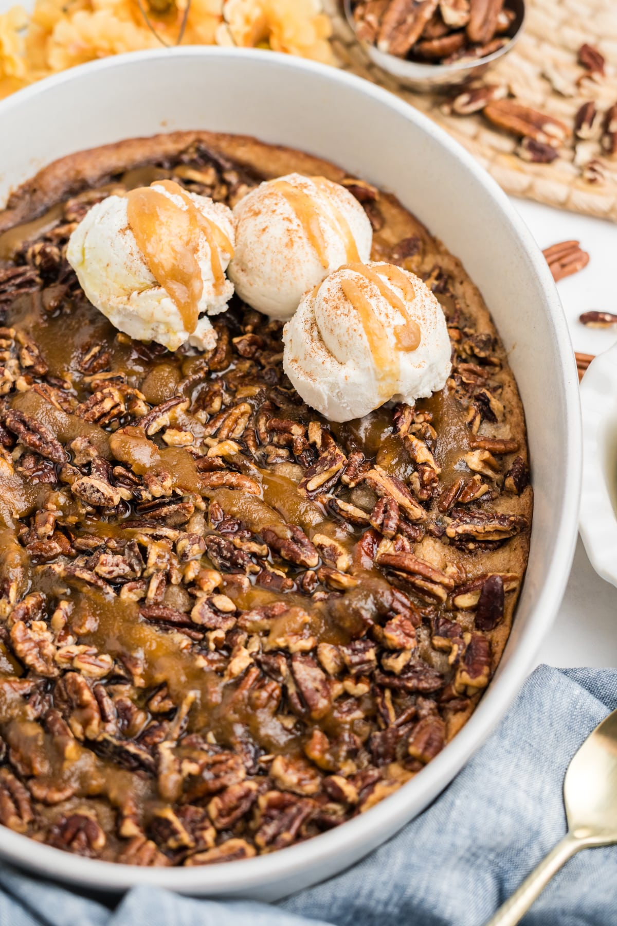 Close up image of pecan pie cobbler in an oval baking dish.