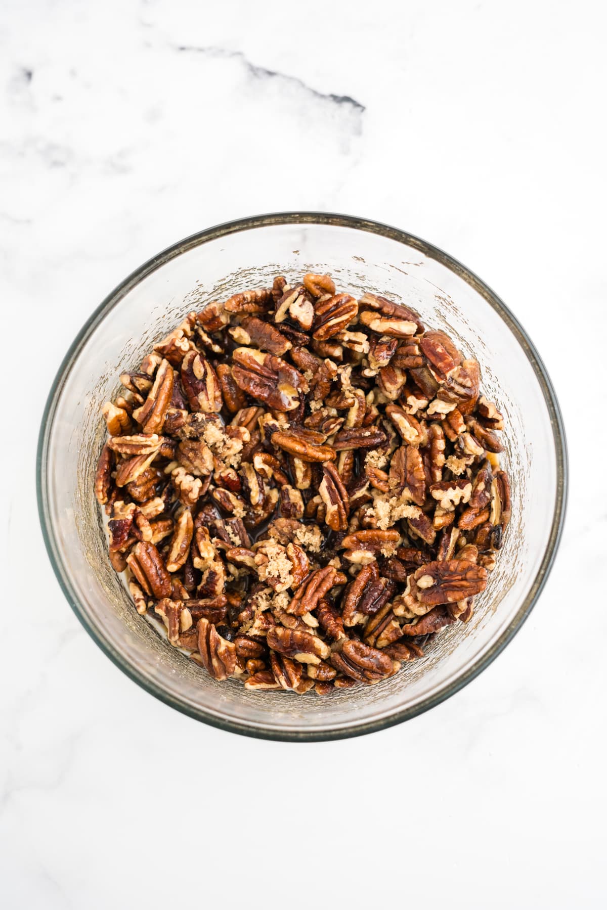 An overhead image of pecan pie cobbler topping being mixed in a bowl.