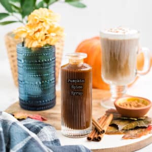 An image of pumpkin spice syrup in a glass bottle with a label that reads pumpkin spice syrup.