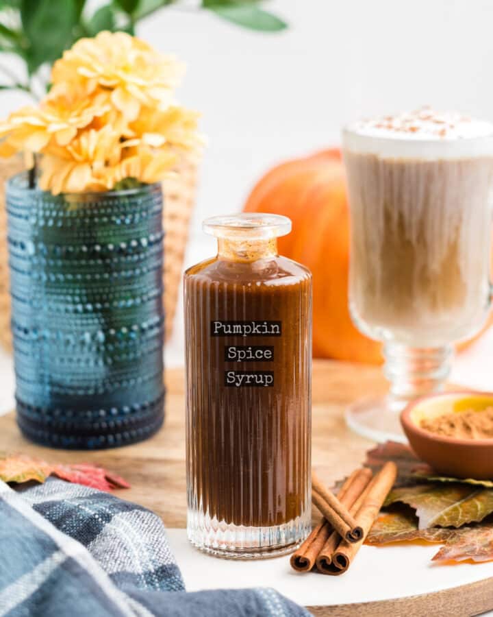 An image of pumpkin spice syrup in a glass bottle with a label that reads pumpkin spice syrup.