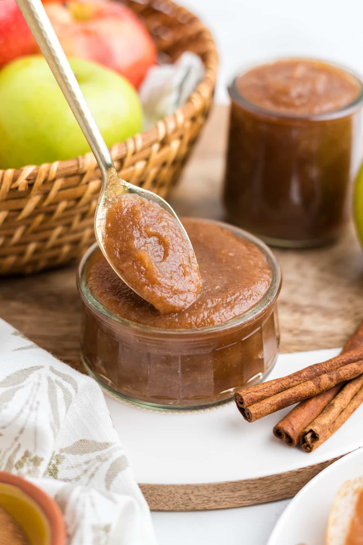 Homemade Slow Cooker Apple Butter being spooned out of a jar. 