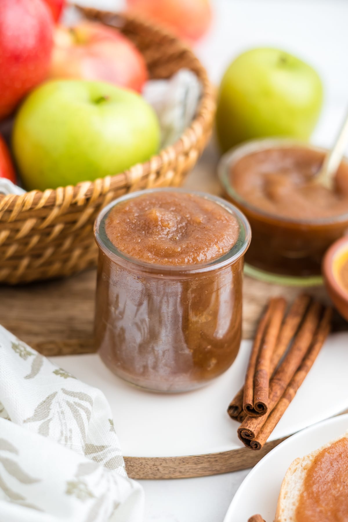 A close up image of crockpot apple butter in a small jar