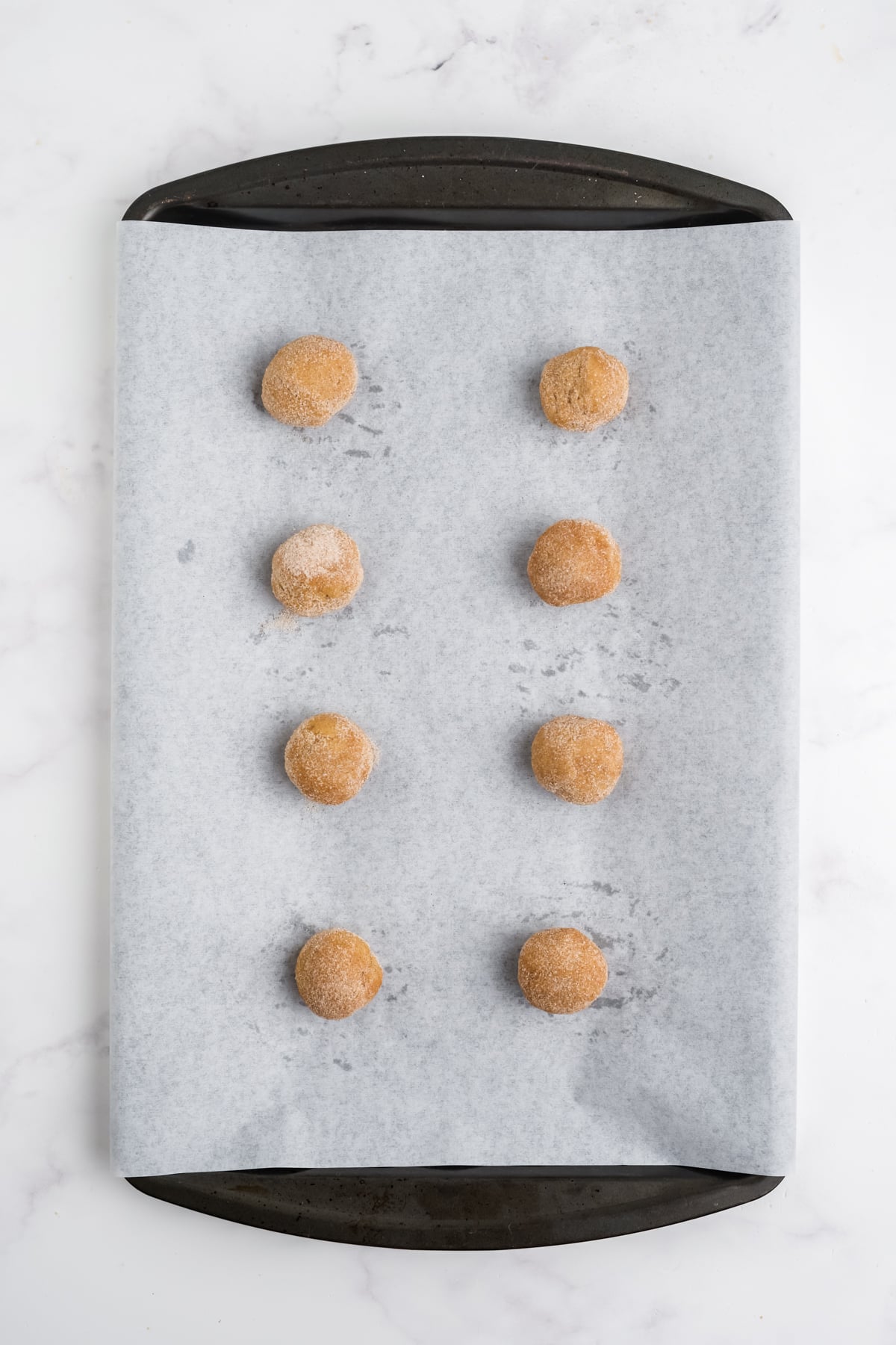 cookie dough balls on a baking sheet