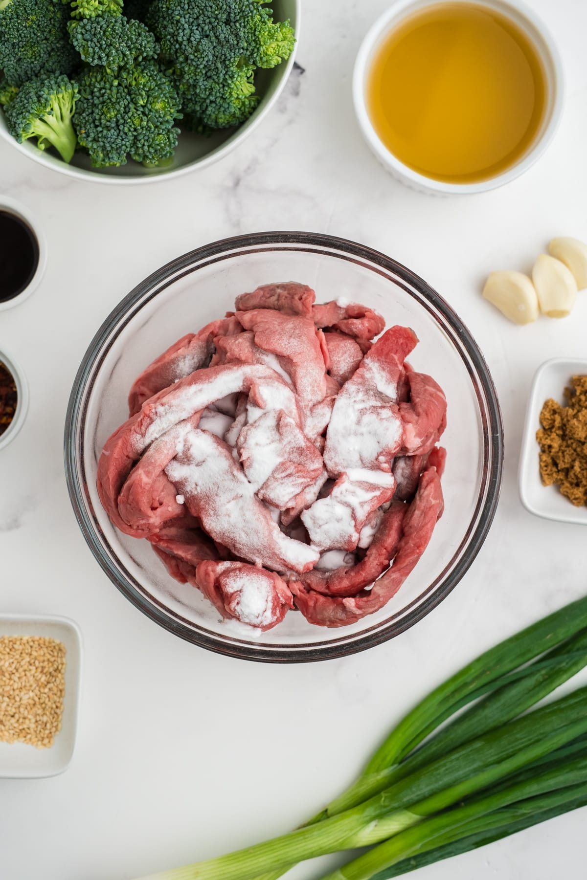 Beef and baking soda in a bowl.