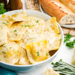 Butternut squash ravioli sauce in a bowl on a table.