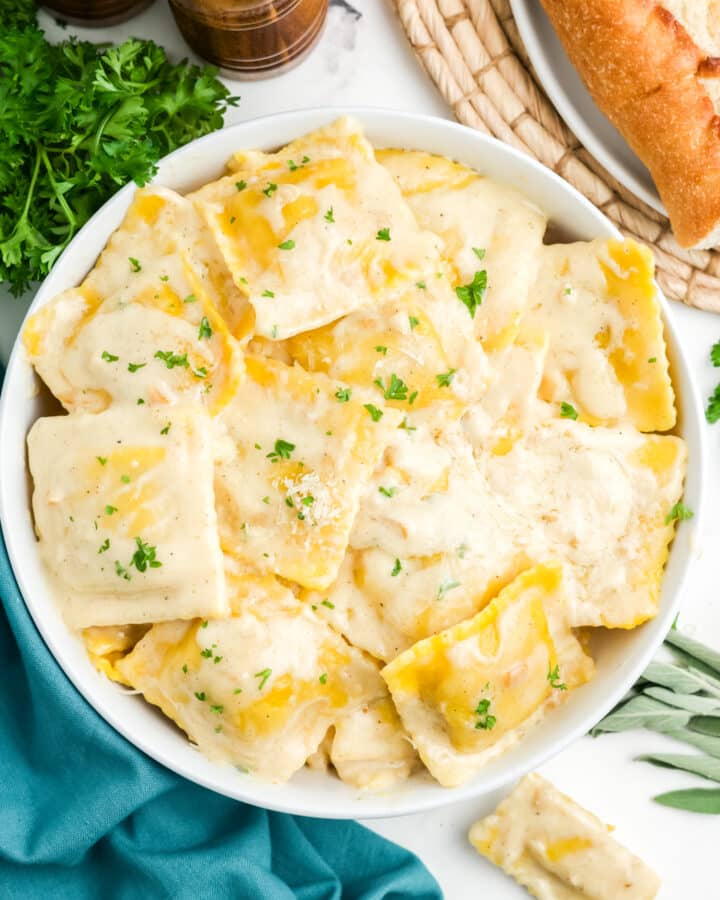 Butternut squash ravioli sauce in a bowl on a table.