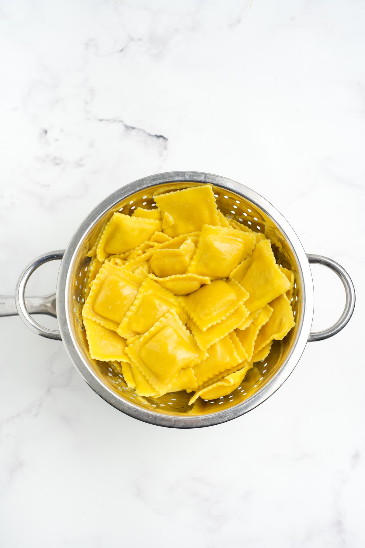 Ravioli draining in a strainer. 