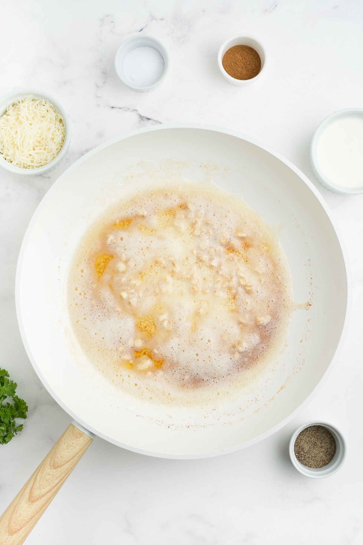 Garlic, butter and sage mixture in the pan.